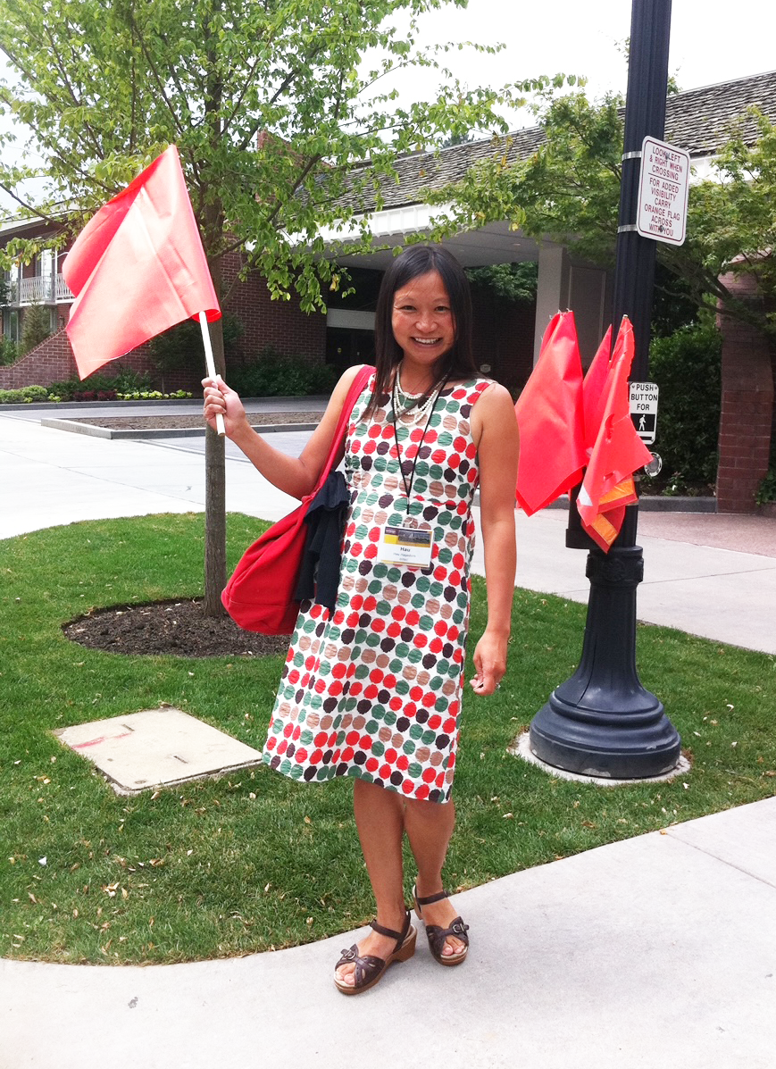 Hau Hagedorn demonstrates a red pedestrian crossing flag